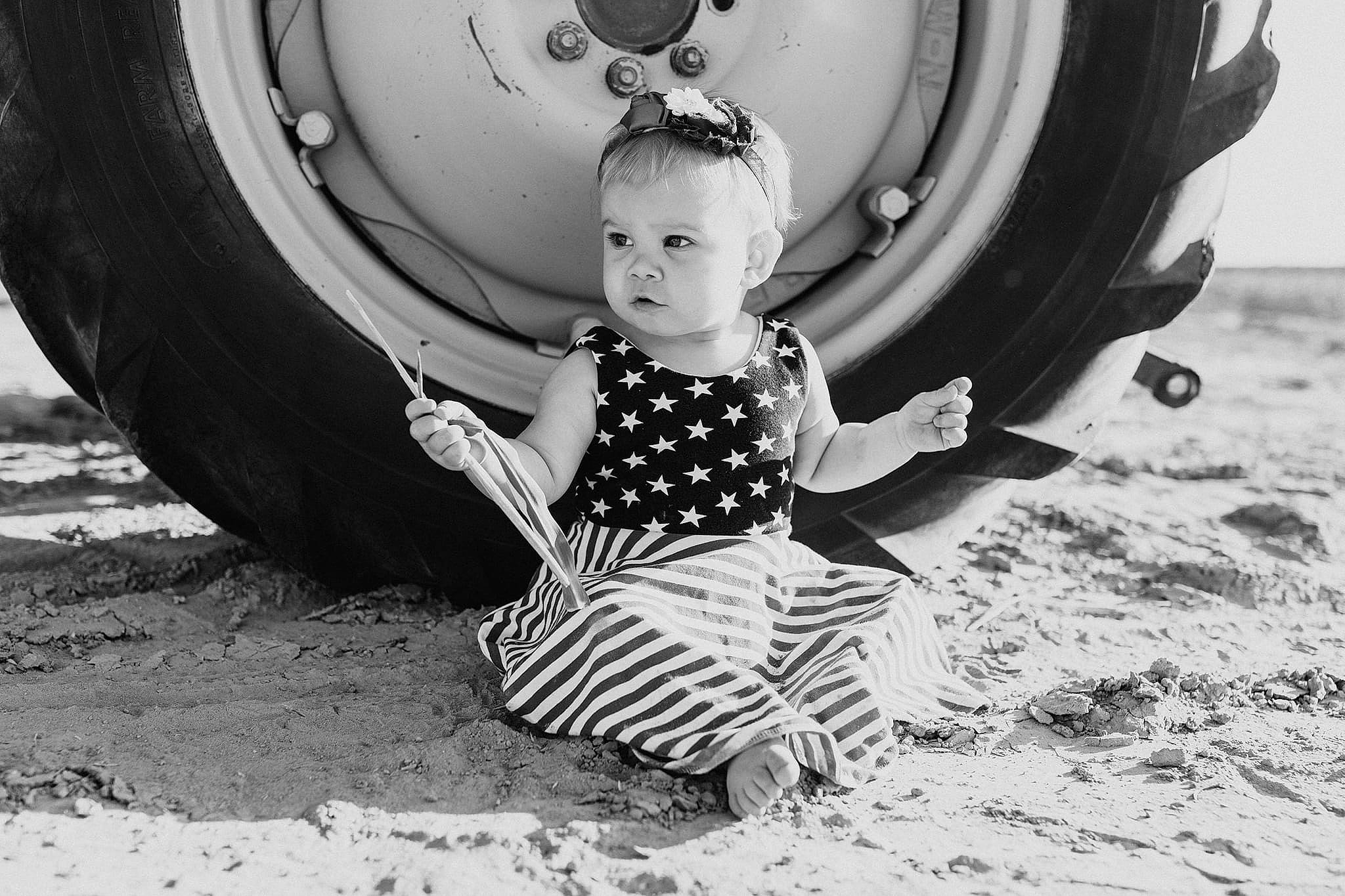 Charli joined the competition — help win amazing prizes! automotive_exterior, automotive_tire, bumper, fun, grass, happy, leisure, monochrome, monochrome_photography, motor_vehicle, person, photograph, recreation, rim, sneakers, style, tire, toddler, tree, wheel