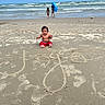 Joseph is registered to the contest to win money with this photo: baby, child, beach, sand, ocean, waves, sky, clouds, water, shorts, float, playing, summer, vacation, outdoor, kids, fun, sunny, footprints, name_written_in_sand