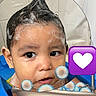 child, toddler, bathtub, bath, shampoo, foam, bubbles, wet_hair, baby, cute, face, water, blue, heart_emoji, playing, indoors, skin, head, expression, cleaning