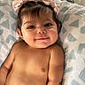 Veronica joined the competition — help win amazing prizes! adorable, baby, blanket, bows, child, closeup, cute, face, happy, indoors, infant, lying_down, person, pigtails, portrait, skin, smile, soft_texture, toddler, young