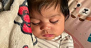 Veronica joined the competition — help win amazing prizes! baby, sleeping, blanket, bow, bottle, cute, face, hair, infant, indoors, patterned_blanket, person, portrait, resting, soft_texture, striped_clothing, toy, baby_seat, animal_print, peaceful