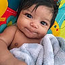 Veronica joined the competition — help win amazing prizes! baby, infant, child, face, eyes, smile, blanket, soft, cute, skin, hair, hand, colorful_background, playmat, indoors, portrait, expression, closeup, young, adorable