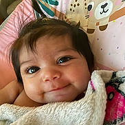 Veronica joined the competition — help win amazing prizes! baby, infant, smile, face, eyes, blanket, cute, child, portrait, closeup, hair, cushion, bear_illustration, soft, cozy, indoors, wrapped, happy, skin, baby_bedding