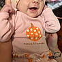Adalyne joined the competition — help win amazing prizes! baby, infant, smiling, pink_clothing, headband, pumpkin_pattern, cute, hands, holding, happy, face, apparel, fabric, child, portrait, cozy, warm_colors, indoor, person, newborn