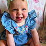 baby, child, smiling, headband, bow, blue_dress, sitting, happy, infant, cute, portrait, indoors, blanket, butterfly_pattern, footwear, colorful_shoes, skin, face, person, young_child