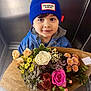 Pablo a rejoint le concours — aidez-le/la à gagner de superbes lots ! beanie, blue_hat, blue_jacket, bouquet, child, chrysanthemums, daisies, elevator, eyes, face, floral_wrapping, flowers, gift, indoor, pink_rose, portrait, rose, smiling, toddler, white_rose