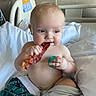baby, infant, hospital_bed, bacon, pacifier, blanket, medical_equipment, child, cute, skin, sitting, bed, hospital_room, food, eating, comfort, toddler, indoors, person, healthcare