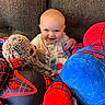 Sawyer joined the competition — help win amazing prizes! baby, child, smiling, plush_toy, stuffed_animal, spiderman, sloth, couch, indoor, happy, cute, soft_toys, seated, portrait, cozy, colorful, fabric, toy, kid, playful