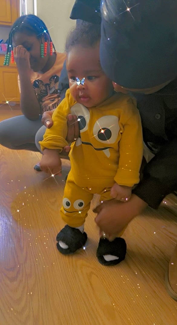 Honesty is registered to the contest to win money with this photo: baby, child, eyewear, flooring, fun, hairstyle, happy, leisure, nose, person, personal_protective_equipment, play, recreation, shorts, skin, t_shirt, thumb, toddler, toy, vacation