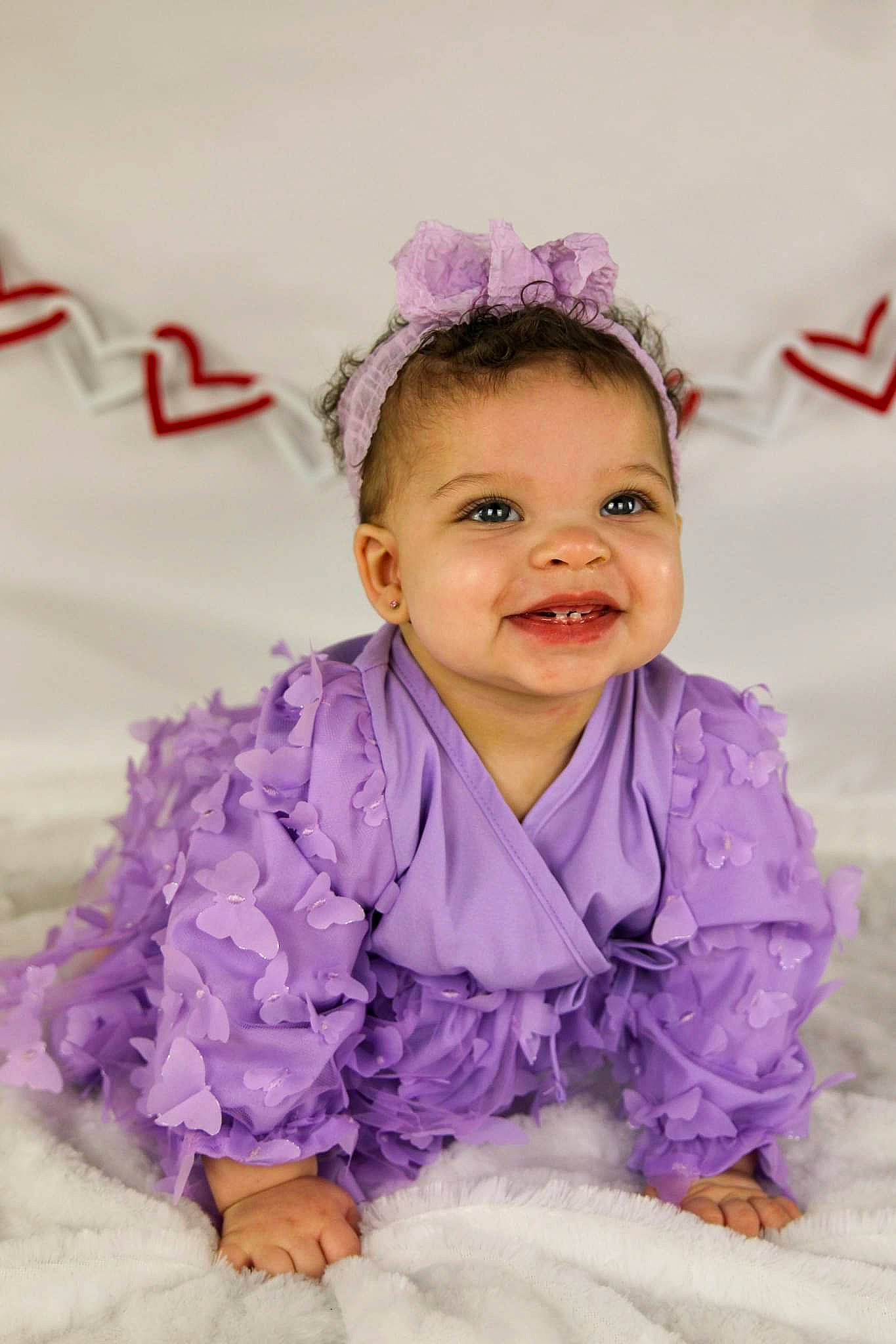Avani is registered to the contest to win money with this photo: baby, baby_toddler_clothing, child, costume, dress, event, fashion_accessory, fun, hair_accessory, happy, head, headband, headpiece, joy, magenta, person, pink, purple, sleeve, smile