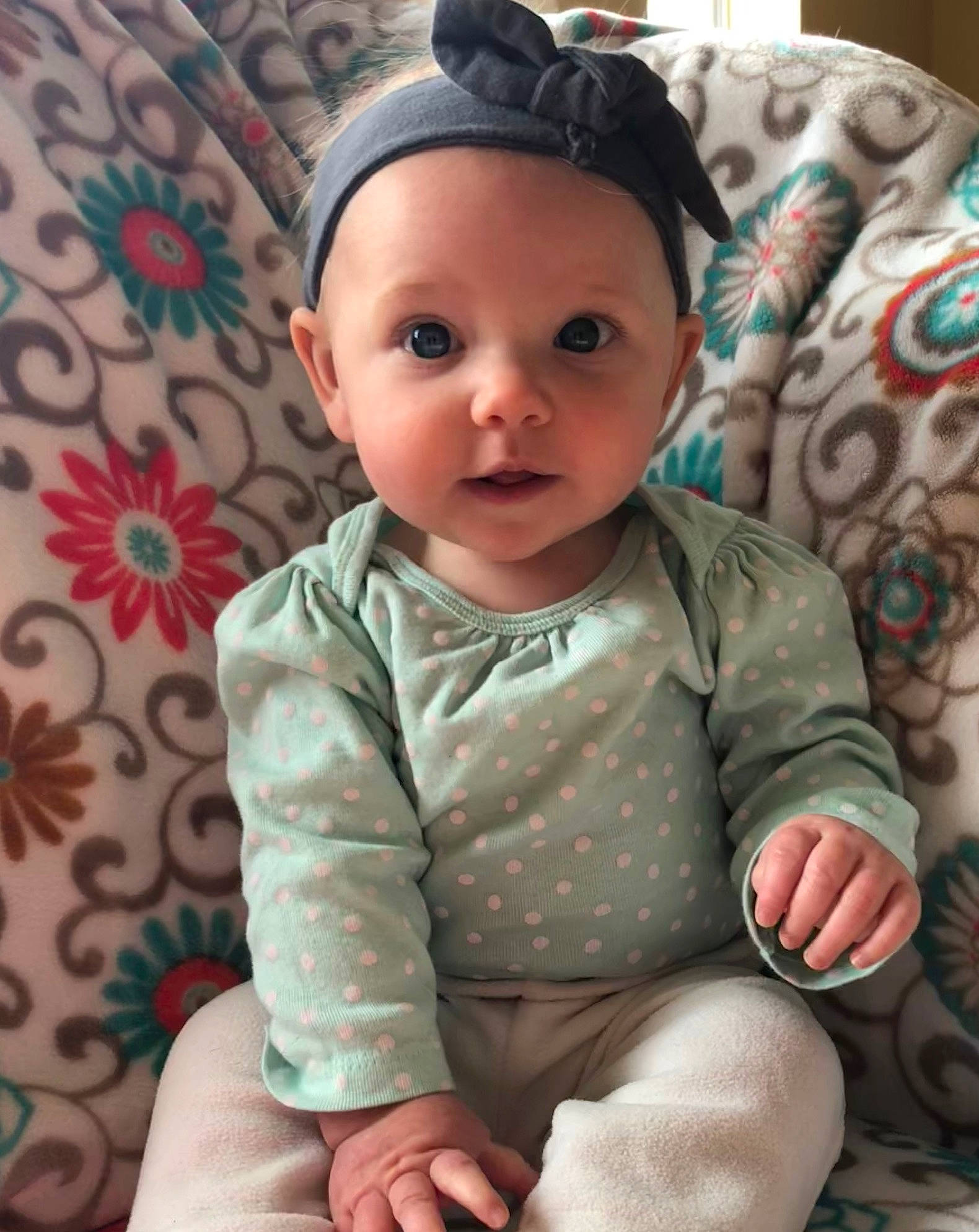 Austyn joined the competition — help win amazing prizes! baby, baby_toddler_clothing, cheek, child, eye, face, hair_accessory, head, headgear, pattern, person, sitting, skin, sleeve, smile, toddler