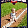 Walter is registered to the contest to win money with this photo: baby, child, baseball_field, grass, dirt, line, sitting, white_clothing, shorts, sunlight, shadow, sports, rookie, all_american, text_overlay, portrait, outdoor, person, cute, determined