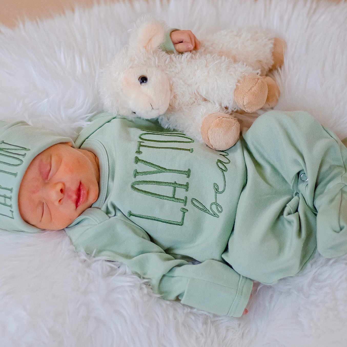 Layton is registered to the contest to win money with this photo: baby, blanket, bodypart, cap, clothing, couch, face, finger, furniture, hand, hat, head, knitwear, newborn, person, photography, portrait, sleeping, teddybear, toy