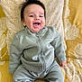 Niță Damian a rejoint le concours — aidez-le/la à gagner de superbes lots ! baby, child, comfortable, couch, cozy, cushion, face, gray_clothing, hair, happy, indoor, infant, joyful, leaf_pattern, portrait, sitting, smiling, tracksuit, young_child, zipper