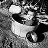 Theodore joined the competition — help win amazing prizes! toddler, child, metal_tub, water, outdoor, black_and_white, playful, tongue_out, rocks, tree_trunk, rustic, dirt, tools, wheel, sunlight, shadow, person, candid, fun, smile