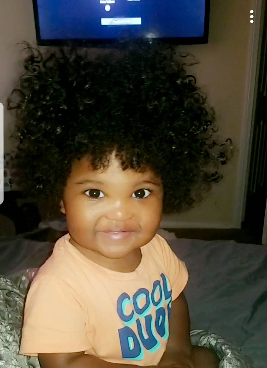 Asa is registered to the contest to win money with this photo: afro, baby_toddler_clothing, black_hair, blue, cheek, cool, eye, eyebrow, eyelash, forehead, fun, hair, happy, head, iris, joy, nose, person, smile, television