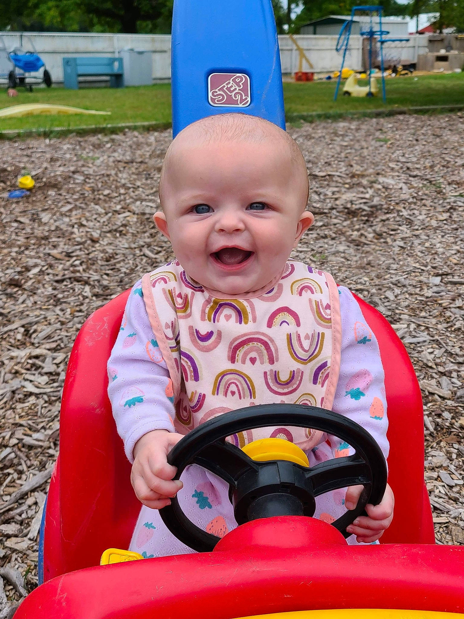 Hadleigh joined the competition — help win amazing prizes! baby, baby_toddler_clothing, child, event, fun, grass, happy, human_body, leisure, orange, person, photograph, pink, plant, playground, public_space, recreation, riding_toy, smile, toddler