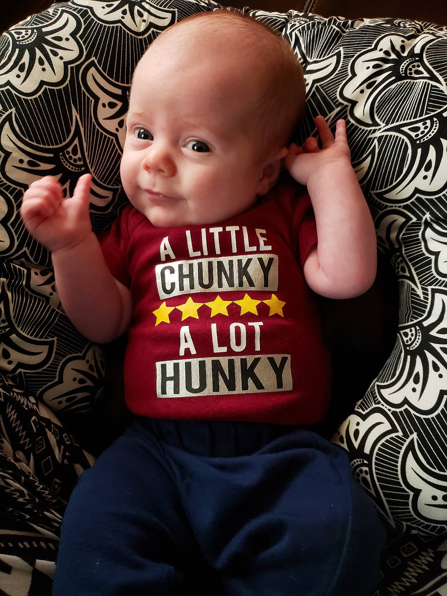 Ronan is registered to the contest to win money with this photo: baby, baby_products, baby_toddler_clothing, cheek, child, cool, person, product, sitting, sleeve, smile, t_shirt, toddler