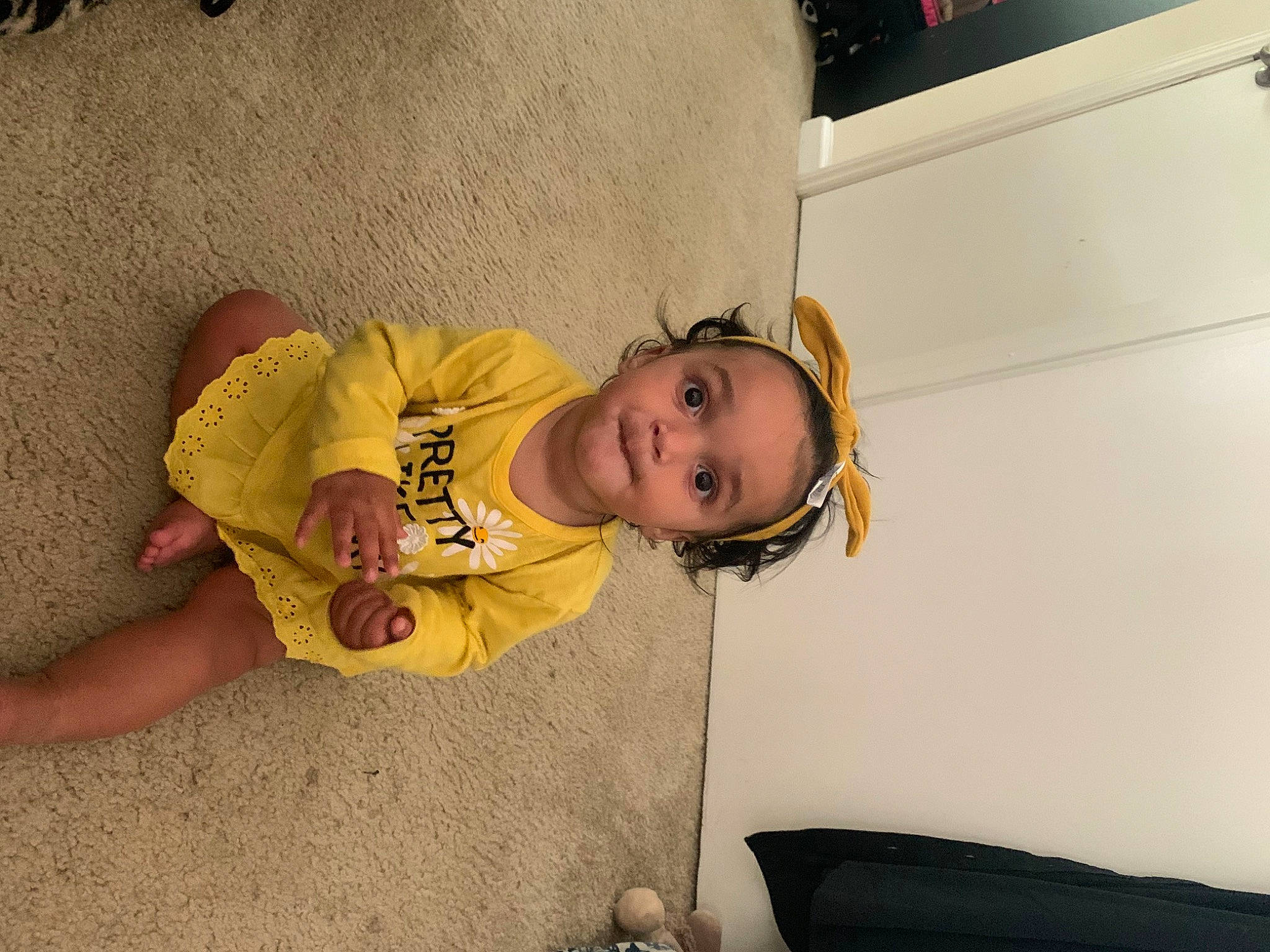 Isla is registered to the contest to win money with this photo: baby, baby_toddler_clothing, cheek, child, comfort, flooring, fun, happy, hat, person, room, sitting, sleeve, toddler, vacation, wood