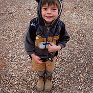 Kamren joined the competition — help win amazing prizes! child, smiling, hoodie, bear_ears, backpack, boots, gravel, outdoor, cute, happy, young_child, casual_clothing, standing, portrait, nature, brown, gray, playful, kid, fall