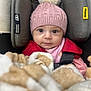 adorable, baby, blanket, car_seat, child, close_up, cozy, cute, face, indoor, infant, looking_at_camera, pink_hat, pom_pom, portrait, red_clothing, seatbelt, soft_texture, warm_clothing, wide_eyes