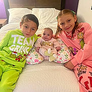 Khaleesi is registered to the contest to win money with this photo: baby, bed, blanket, child, clothing, cozy, cute, face, family, grinch, happy, head, holiday, indoor, pajamas, person, pillow, portrait, sibling, smile