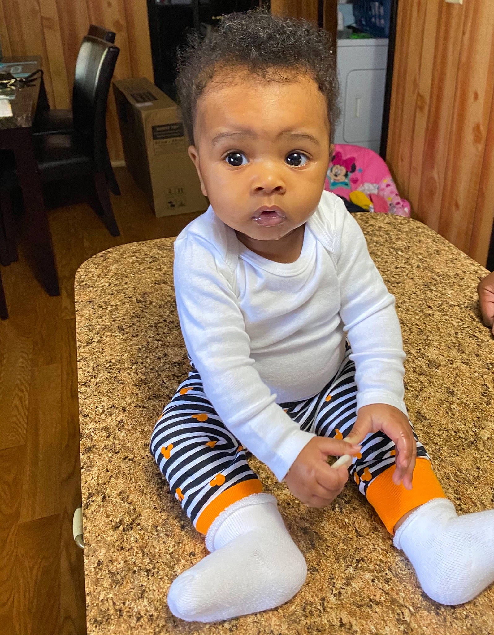 Alayla is registered to the contest to win money with this photo: ankle, baby, baby_grabbing_for_something, baby_products, baby_toddler_clothing, child, door, eye, floor, flooring, foot, living_room, person, play, sock, toddler, toe, wood_stain