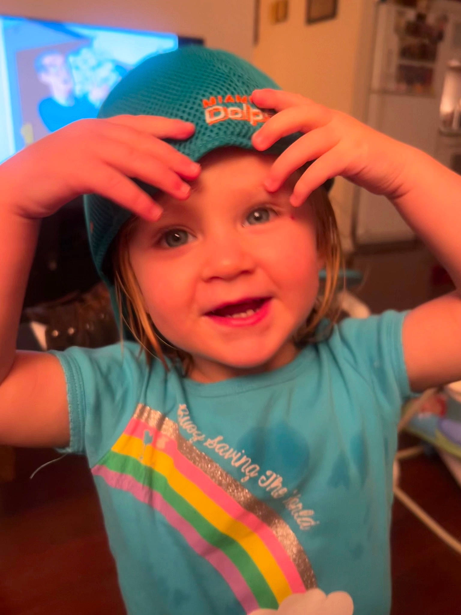 Jamie is registered to the contest to win money with this photo: arm, cap, child, event, eyelash, finger, fun, gesture, happy, headgear, headwear, iris, mouth, orange, party_supply, person, pink, skin, smile, t_shirt