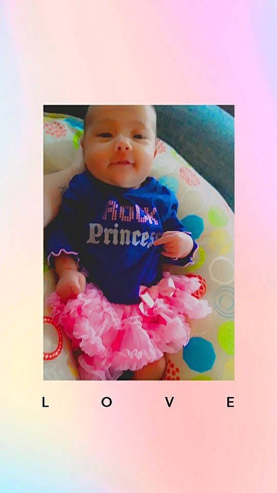 Indigo is registered to the contest to win money with this photo: baby, baby_toddler_clothing, cheek, child, person, photo_caption, pink, play, smile, toddler