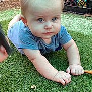Legend joined the competition — help win amazing prizes! baby, blue_shirt, casual, child, crawling, curious, daylight, expression, face, grass, green, hands, infant, lawn, outdoor, person, playing, toy_crate, wooden_fence, young_child