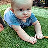 baby, blue_shirt, casual, child, crawling, curious, daylight, expression, face, grass, green, hands, infant, lawn, outdoor, person, playing, toy_crate, wooden_fence, young_child