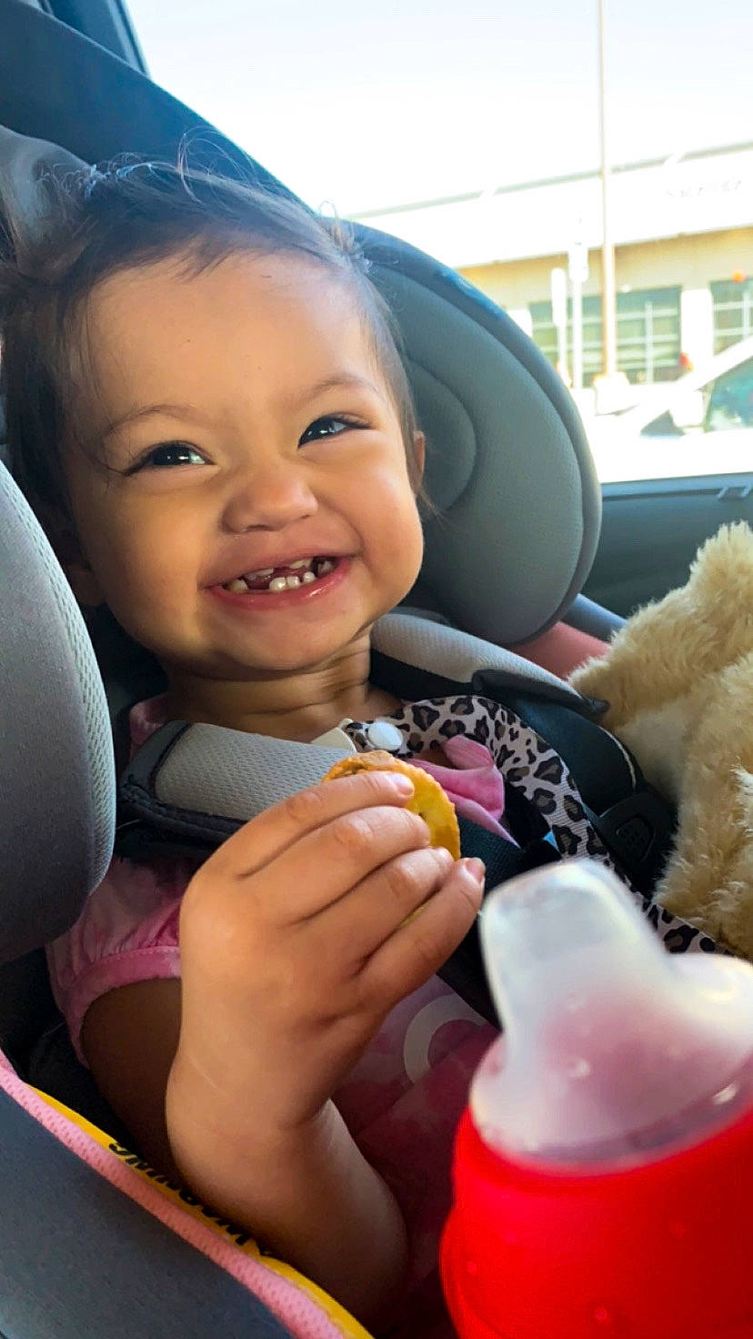 Esperanza is registered to the contest to win money with this photo: auto_part, baby, car_seat, car_seat_cover, child, family_car, finger, fun, happy, joy, luxury_vehicle, motor_vehicle, nail, person, skin, smile, steering_wheel, stuffed_toy, thumb, toddler