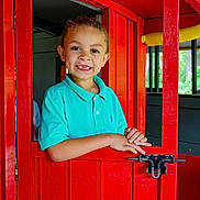 Memphis joined the competition — help win amazing prizes! blue_shirt, bright_colors, casual_clothing, child, curly_hair, door, expression, face, hands, happy, home, indoors, person, playful, portrait, red, smile, window, wood, young