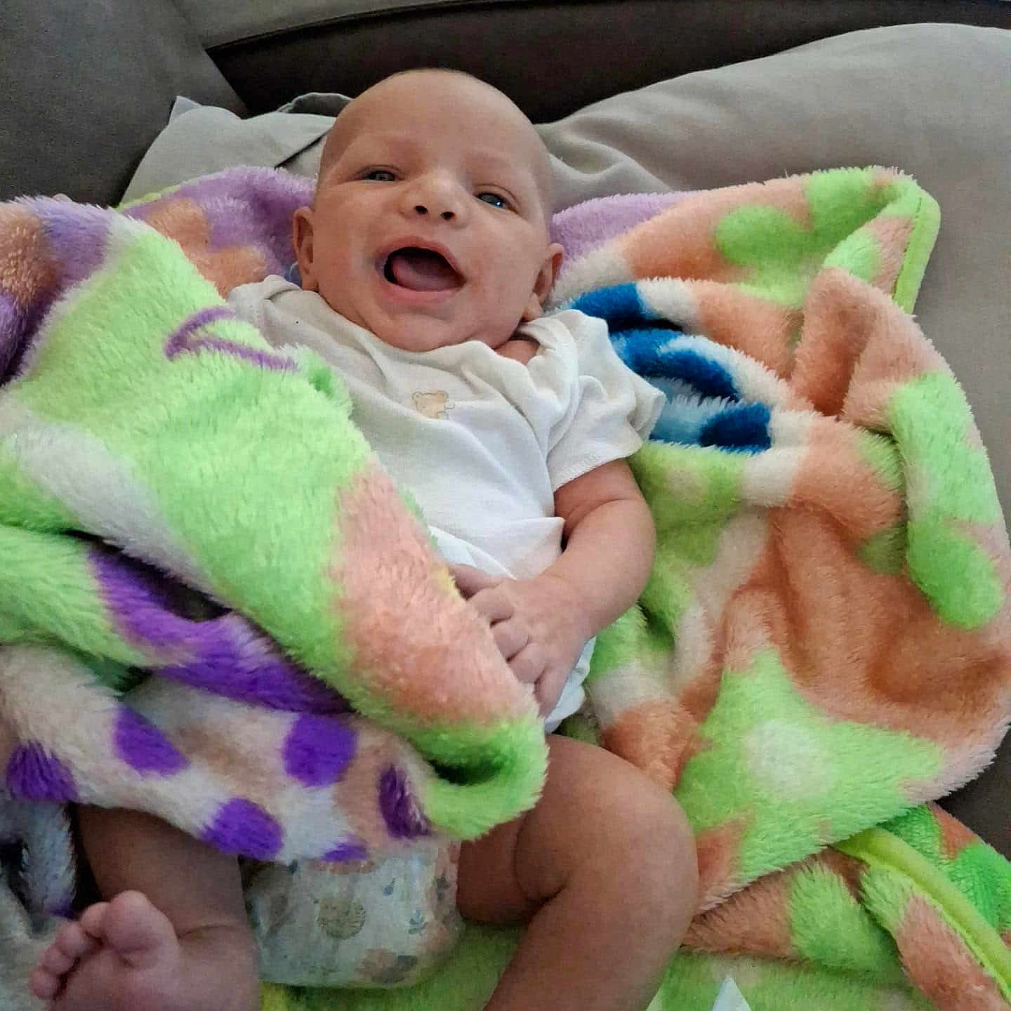 Steven joined the competition — help win amazing prizes! baby, blanket, clothing, colorful, comfort, couch, diaper, face, foot, fuzzy, hand, happy, home, indoor, infant, joy, person, relaxing, smile, soft