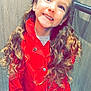 child, smiling, red_coat, curly_hair, long_hair, indoor, elevator, wood_panel, happy, person, portrait, standing, clothing, cute, girl, jacket, fashion, casual, young, bright