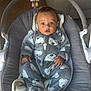 baby, infant, onesie, polar_bear_pattern, baby_rocker, plush_toy, gray, white, cozy, soft, blanket, indoor, child, cute, wide_eyes, seated, clothing, warm, expression, comfort