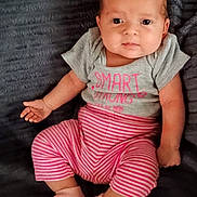 Layla is registered to the contest to win money with this photo: baby, infant, child, face, eyes, clothing, shirt, pants, striped_pants, socks, pink, grey, blanket, texture, portrait, cute, smile, hand, feet, sitting