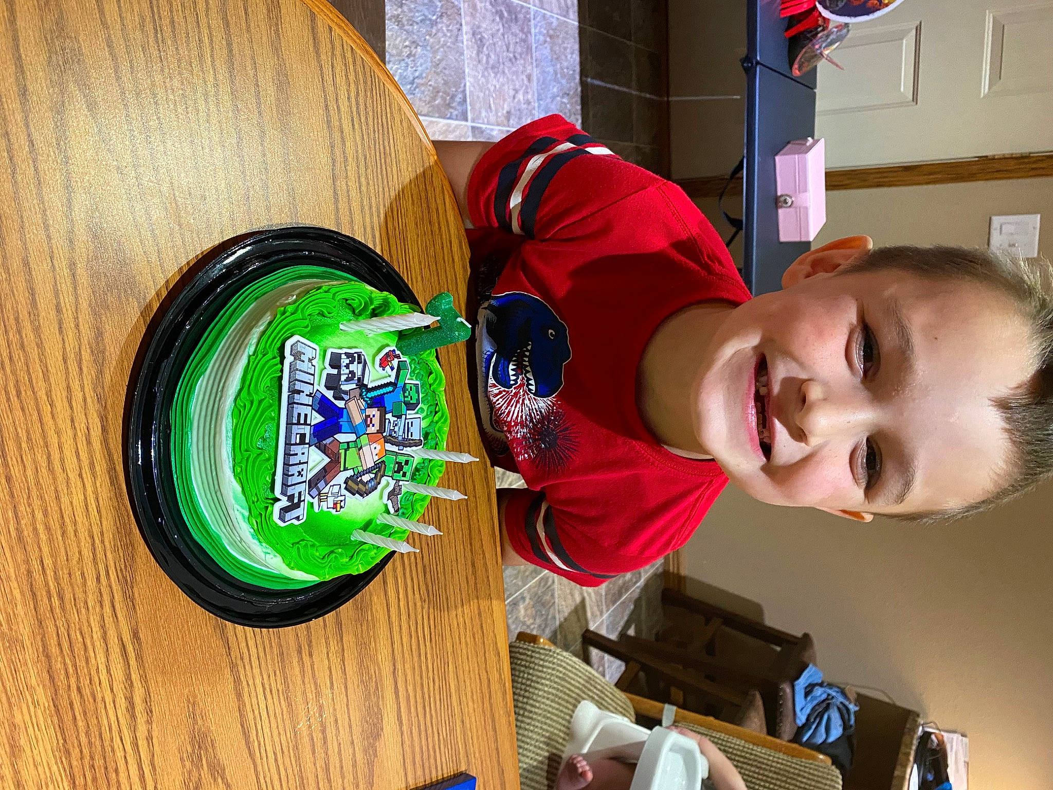 Kyler is registered to the contest to win money with this photo: beer, child, circle, drink, electric_blue, fun, happy, hat, headgear, joy, paint, person, play, room, smile, t_shirt, table, toddler, toy, varnish