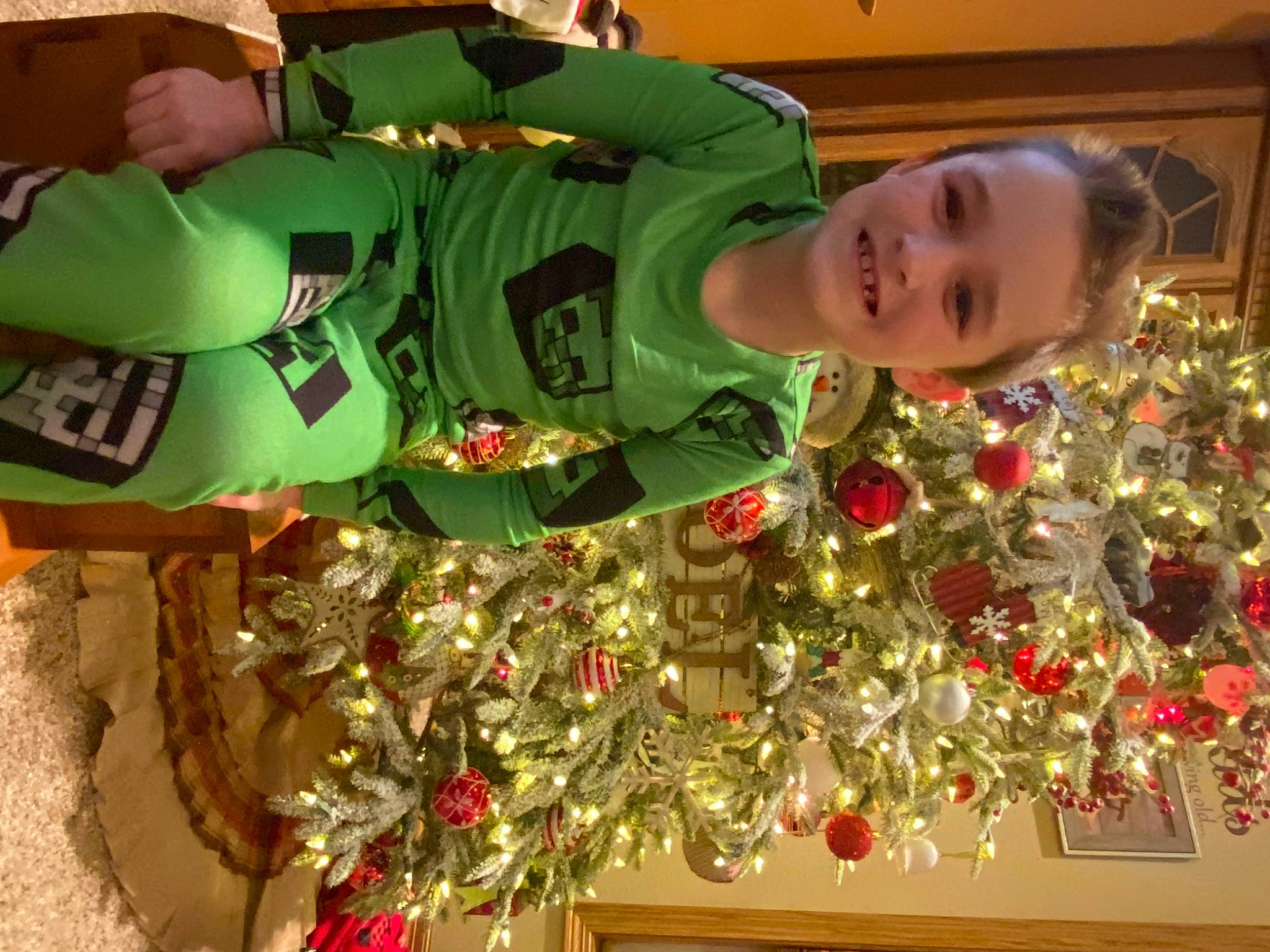 Kyler joined the competition — help win amazing prizes! carmine, child, christmas, christmas_decoration, christmas_eve, christmas_ornament, christmas_tree, event, fun, holiday, holiday_ornament, interior_design, joy, ornament, person, plant, room, sleeve, smile, toddler