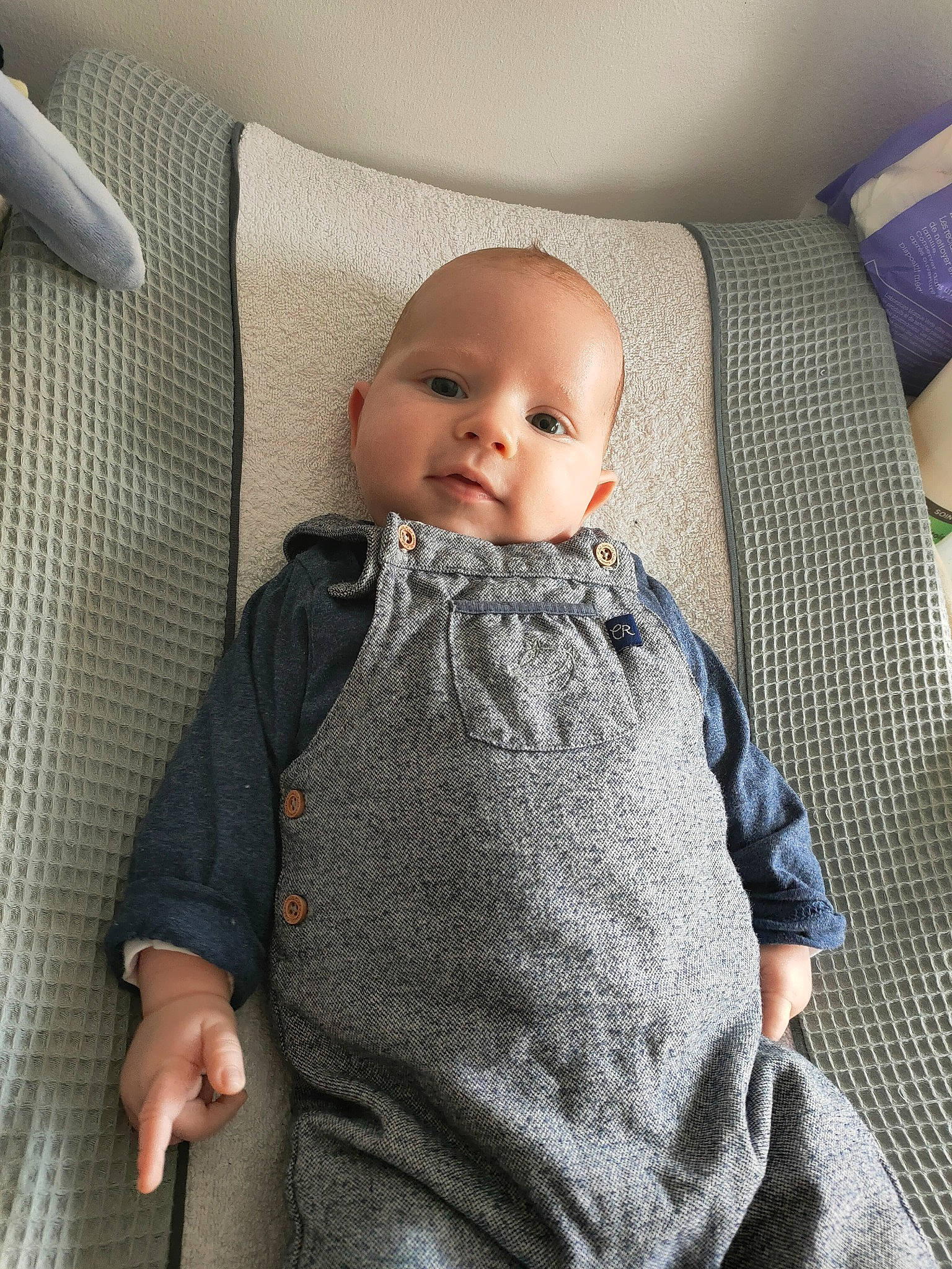 Ethan participe au concours pour gagner de l'argent avec cette photo : baby, baby_toddler_clothing, cheek, child, clothing, collar, comfort, couch, grey, head, linens, pattern, person, product, sitting, skin, sleeve, smile, t_shirt, textile