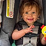 baby, child, car_seat, smile, happy, toy, infant, seatbelt, clothing, hair, face, hand, sitting, safety, cute, young_child, indoor, child_safety, portrait, infant_toy