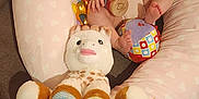 Sofia participe au concours pour gagner de l'argent avec cette photo : baby, infant, smiling, plush_toy, unicorn, giraffe, cushion, heart_pattern, wooden_toy, colorful, indoor, child, cute, happy, seated, soft_toys, fabric, person, playtime, cozy