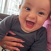 Isaac participe au concours pour gagner de l'argent avec cette photo : baby, smile, happy, child, infant, face, hand, clothing, person, indoor, curtains, holding, joy, cute, young, skin, eyes, cheeks, mouth, sitting