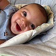 Liam joined the competition — help win amazing prizes! baby, smiling, face, infant, child, happy, cushion, seat, clothing, indoor, portrait, skin, head, eyelashes, mouth, cheeks, baby_seat, cute, young, relaxing
