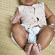 Aj Sarvesh joined the competition — help win amazing prizes! baby, infant, child, barefoot, diaper, sleeveless_top, bracelet, woven_mat, lying_down, cute, curious, skin, foot, hand, face, indoors, casual, expression, small_mark, playful