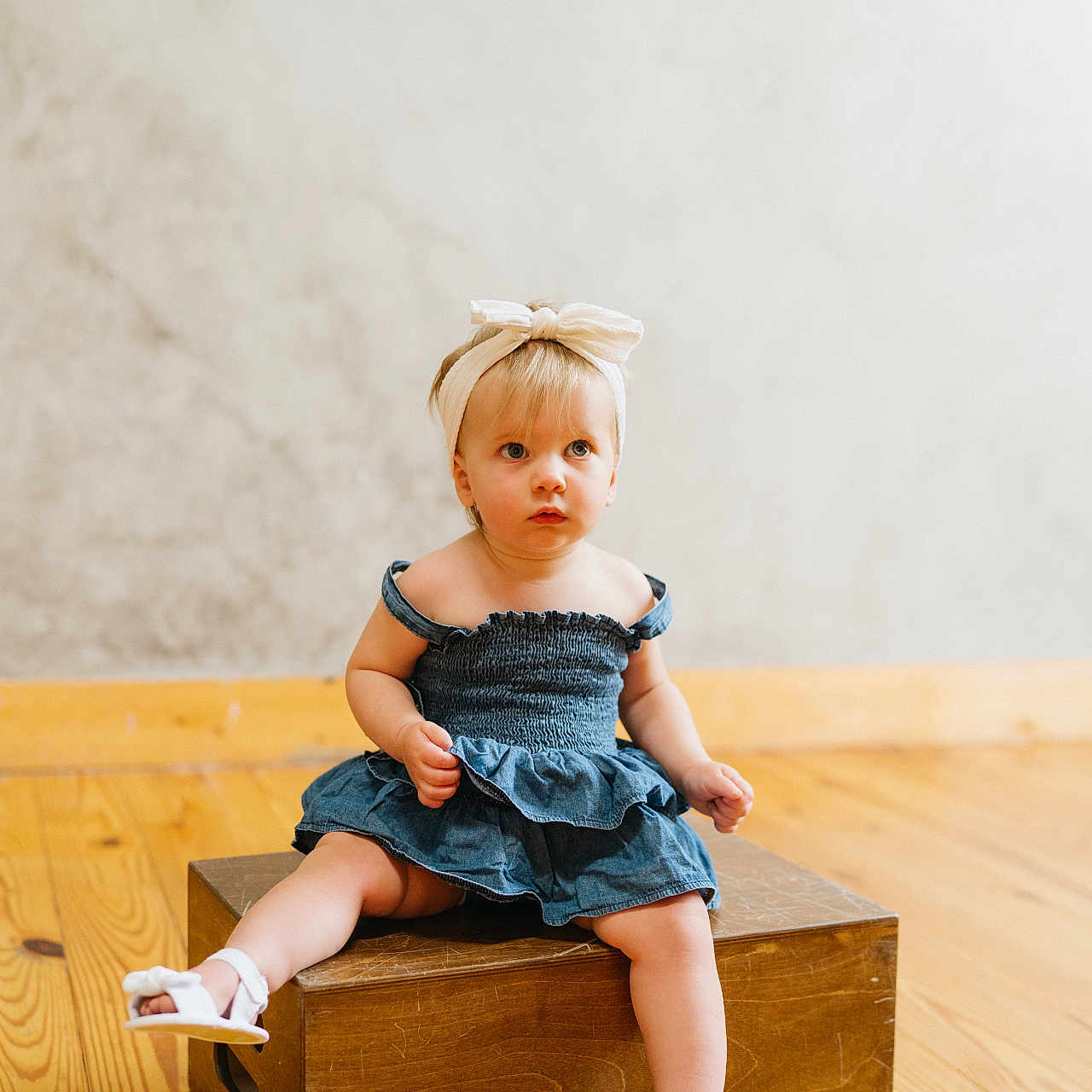 Harper is registered to the contest to win money with this photo: baby, clothing, dress, face, footwear, formalwear, furniture, hardwood, head, jeans, pants, person, photography, plywood, portrait, sandal, shoe, shorts, sitting, wood