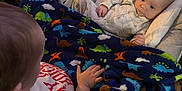 Moses is registered to the contest to win money with this photo: baby, bed, blanket, car, couch, crib, cushion, face, furniture, head, homedecor, infantbed, newborn, person, photography, portrait, quilt, towel, transportation, vehicle