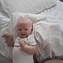 Luca joined the competition — help win amazing prizes! arm, baby, bed, blanket, candid, child, cozy, furniture, happy, head, indoor, infant, motion_blur, person, pillow, skin, sleepwear, smiling, soft_light, white_onesie