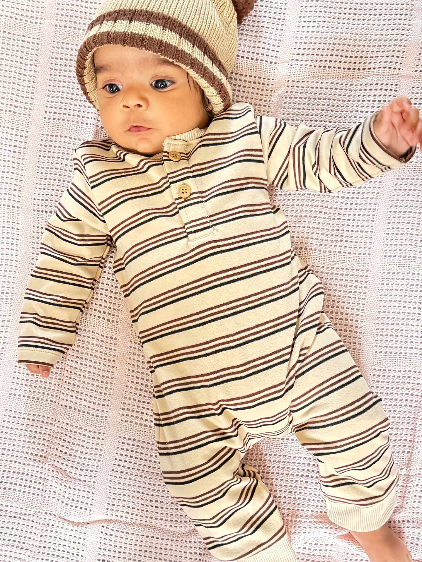 Naithan is registered to the contest to win money with this photo: baby, infant, striped_clothing, knit_hat, blanket, lying_down, cute, child, portrait, one_person, indoors, soft_texture, warm_clothing, cozy, baby_girl, baby_boy, small_hands, sleepwear, newborn, looking_away