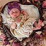 baby, newborn, sleeping, lace_dress, headband, heart_shaped_basket, floral_arrangement, flowers, purple, pink, soft_fabric, blanket, peaceful, infant, cute, portrait, indoors, decor, closeup, resting